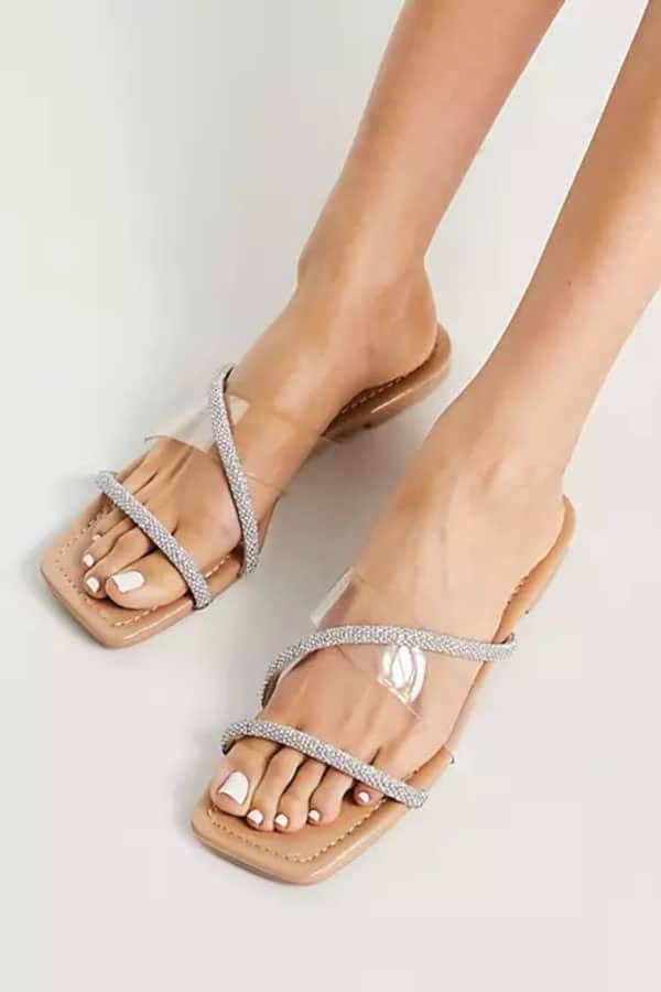 Flat sandal with clear band and embellished straps.