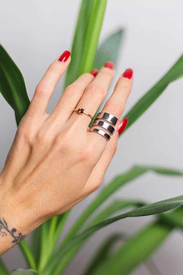Close up of woman's fingers with ring stack.