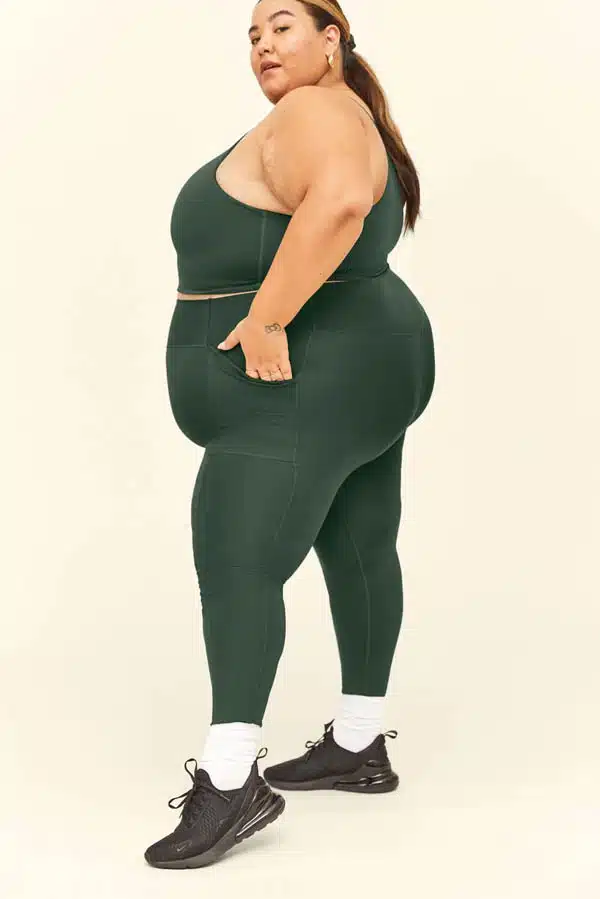 Model wears leggings in plus-size from Girlfriend Collective.