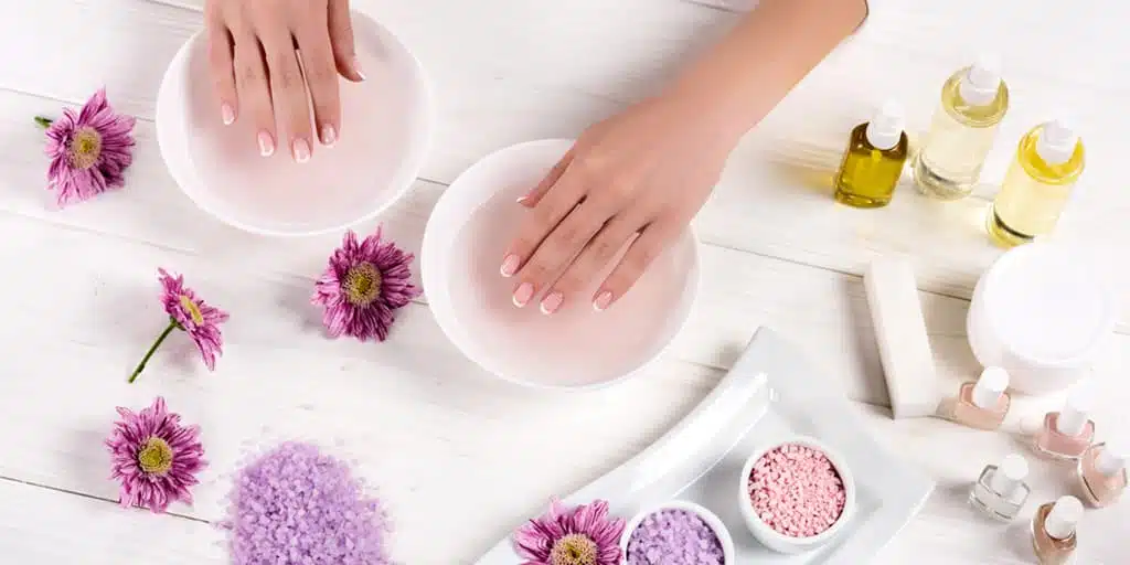 Nail salon table with woman's hands