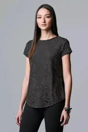 Model wearing black jacquard top by Simply Vera.